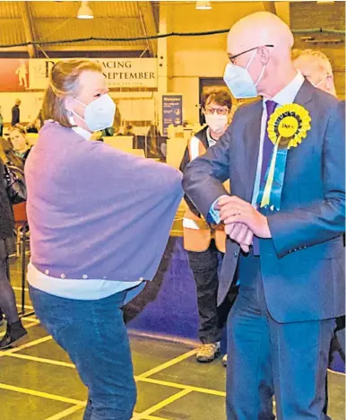  ??  ?? Saturday, May 8, 2021
RING THE BELL’S: John Swinney elbow bumps Kate Howie at Bell’s Sports Centre in Perth after his majority rose; below, the SNP’s Mairi Gougeon enjoys her victory at the Saltire Leisure Centre in Arbroath. Pictures by Steve MacDougall and Kim Cessford.
