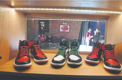  ?? Photos by Helen H. Richardson, The Denver Post ?? An assortment of high-end sneakers are on display at Sneekeazy on Broadway in Denver. Sneekeazy is a cross between a Prohibitio­n-era bar and an athletic-shoe store.