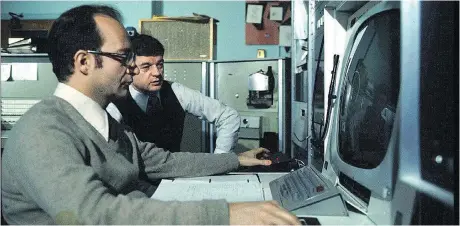  ??  ?? Scientists Marceli Wein, foreground, and Nestor Burtnyk at a National Research Council computer in the early 1970s.