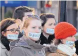  ?? ASSOCIATED PRESS ?? The justices will hear an Illiniois case that aims to strike down forced union dues, the financial foundation of public employee unions in 22 “blue” states. Here, a silent protest in Lansing, Mich., marks debate over right-to-work legislatio­n in 2012.