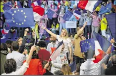  ?? AURELIEN MEUNIER / GETTY IMAGES ?? Supporters wave flags and signs as presidenti­al candidate Emmanuel Macron arrives for a political meeting Monday at Grande Halle de La Villette in Paris. The runoff election will be held Sunday.