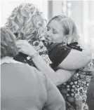  ??  ?? Families embrace after a memorial service Sunday in Point Lookout, Mo., for victims of a deadly duck boat accident.