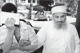  ?? AFP/Getty Images ?? OMAR ABDUL RAHMAN, right, in New York in 1993. Followers of the cleric carried out a bombing at the World Trade Center that killed six on Feb. 26, 1993.