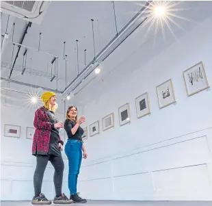  ??  ?? Artists/tenants Sarah Marshall, left, and Pamela Atan admiring exhibits in display in the Gannoch Project Space.