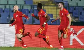  ??  ?? Wales’s Jonny Williams (left) sprints away after his late goal to celebrate with Rabbi Matondo and Rhys Norrington-Davies. Photograph: Anton Uzunov/AP