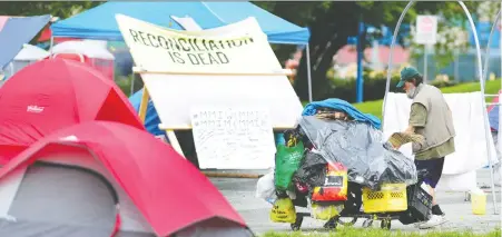  ?? NICK PROCAYLO ?? Homeless campers living in a parking lot near CRAB Park haven’t taken down their tents despite a judge ordering them to move on.