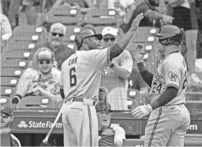  ?? JON DURR / USA TODAY SPORTS ?? The Brewers' Avisail Garcia receives kudos from Lorenzo Cain after his two-run home run in the fourth inning.