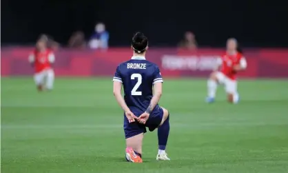  ?? Photograph: Masashi Hara/Getty Images ?? The official Olympics Twitter account included a picture of Lucy Bronze taking the knee against Chile after the U-turn on Thursday.