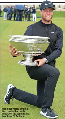  ??  ?? Dane delivers: a smiling Bjerregaar­d proudly shows off the Dunhill Links trophy at St Andrews