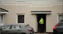  ??  ?? Specialist gas investigat­ors, right, at the home following the discovery, while left, a police officer stands guard at the South Side property