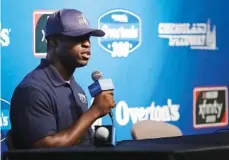  ?? THE ASSOCIATED PRESS ?? Jesse Iwuji speaks Friday at a news conference for the NASCAR Cup Series race at Chicagolan­d Speedway in Joliet, Ill. Iwuji is a lieutenant in the U.S. Navy who also competes in NASCAR’s K&N Pro Series.