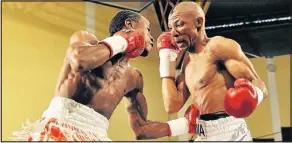  ??  ?? TOUGH BLOWS: Simphiwe Tom, left, lands a blow to his opponent Molefe Matima’s midriff during their fight held at the Orient Theatre. Molefe will be fighting Mbulelo Transvaal at the OR Tambo Hall in Mthatha on July 27