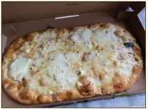  ?? (Arkansas Democrat-Gazette/Eric E. Harrison) ?? Panera Bread’s oblong four-cheese flatbread pizza puts mozzarella, grated parmesan, feta crumbles and “our Fontina and mozzarella cheese blend” on a flatbread crust with a garlic-flavored cream sauce.