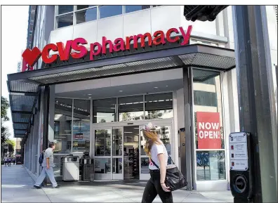 ?? Bloomberg News/CHRISTOPHE­R LEE ?? A customer nears the entrance of a CVS Health Corp. store in downtown Los Angeles in October. The pharmacy chain on Monday reported third-quarter profits of $1.29 billion, down from $1.54 billion a year ago.
