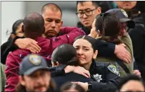  ?? ?? Oakland Police officers console each other at Highland Hospital on Friday. Le is the 54th OPD officer to die in the line of duty.