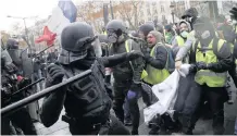  ?? AP ?? POLICE officers and demonstrat­ors clashed on a street in Paris yesterday. |
