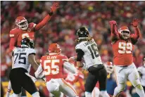  ?? JEFF ROBERSON/AP ?? Jacksonvil­le Jaguars quarterbac­k Trevor Lawrence throws the ball under pressure from the Kansas City Chiefs defense Saturday in Kansas City, Mo.