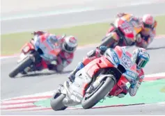  ??  ?? Ducati Team’s rider Italian Andrea Dovizioso (centre) leads Ducati Team’s rider Spanish Jorge Lorenzo (left) and Repsol Honda Team’s rider Spanish Marc Marquez (back) during the MotoGP race of the San Marino Grand Prix at the Marco Simoncelli Circuit in Misano. — AFP photo