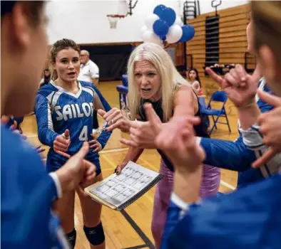  ?? BARRY CHIN/GLOBE STAFF ?? Scituate girls’ volleyball coach Jen Harris (center) started the varsity program almost a decade ago, and has transforme­d the team with the help of her daughter, Sumner.