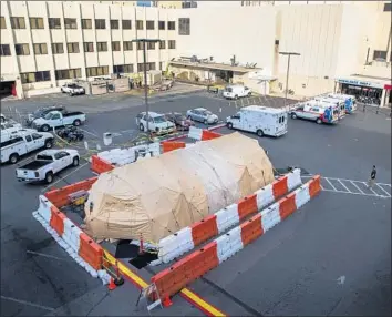  ?? Photograph­s by Gina Ferazzi Los Angeles Times ?? LOMA LINDA University Medical Center is one of many hospitals that have set up extra treatment areas, such as tents, to handle the influx of flu patients. The tent remains almost three weeks after it went up.