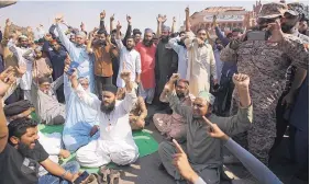  ?? FAREED KHAN/ASSOCIATED PRESS ?? Supporters of a Pakistani religious group chant slogans while they block a main road during a protest after a court decision in Karachi, Pakistan, on Wednesday.