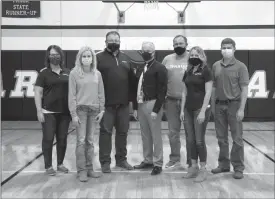  ?? Donnis Hueftle-Bullock ?? Pictured in Ansley High School gym where the mats are located are Jana Henry Flatwater Bank, Danielle Ostrand, Board Member, Brent Custer Shelter Insurance, Gordon Goodman, Superinten­dent, Pete Cunningham, Board President, Danyle Goodman, Flatwater Bank, Joe Hickman, Flatwater Bank.