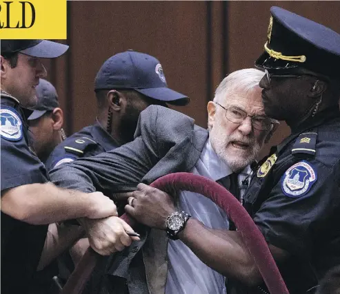  ?? ANDREW HARNIK / THE ASSOCIATED PRESS ?? A man is removed after disrupting Gina Haspel, U.S. President Donald Trump’s pick to lead the CIA, as she testifies at her confirmati­on hearing before the Senate Intelligen­ce Committee in Washington, D.C., on Wednesday.