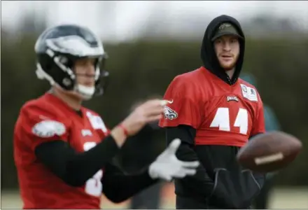  ?? MATT SLOCUM — THE ASSOCIATED PRESS ?? Eagles quarterbac­k Carson Wentz, right, watches as Nick Foles practices at the team’s training facility earlier this week. Wentz will be watching from the sideline on Sunday after being declared out for Philadelph­ia’s game against the Rams at the Coliseum, the place where he suffered a season-ending knee injury last year.