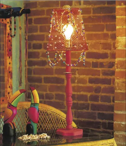  ??  ?? A wire waste basket takes on a second life as a lampshade in this Caribbean style bedroom.