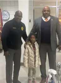  ?? (Special to The Commercial/Pine Bluff Police Department) ?? Lt. DeShawn Bennett and Assistant Chief Kelven Hadley of the Pine Bluff Police Department help a young person out for the holidays.