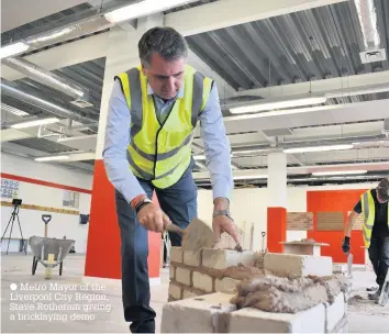  ??  ?? Metro Mayor of the Liverpool City Region, Steve Rotheram giving a bricklayin­g demo