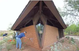  ??  ?? Mudslinger Frank Riley of Phoenix helps refresh the O’Connor House on Friday. Mud is used to provide a protective layer for the 60-year-old bricks. The mud is followed with a coating of non-fat milk to seal the finish and prevent the bricks from giving...