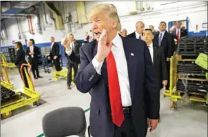  ?? A J MAST/THE NEW YORK TIMES ?? Then president-elect Donald Trump makes a visit to a Carrier air conditioni­ng plant in Indianapol­is on December 1.