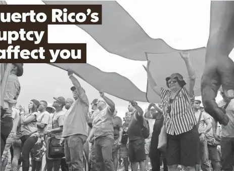  ?? DANICA COTO, AP ?? Demonstrat­ors in San Juan rally against austerity measures May 1. The U.S. territory has lost 20% of its jobs since 2007.