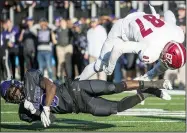  ?? Arkansas Democrat-Gazette/JEFF GAMMONS ?? Ouachita Baptist defensive back Keandre Evans (left) takes out Henderson State tight end Ayden Shurley on a touchdown attempt Saturday during the Southern Bancorp Battle of the Ravine at Cliff Harris Stadium in Arkadelphi­a. The Ouachita Baptist Tigers beat the Henderson State Reddies 24-21 in their third straight win.