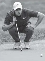  ?? THE ASSOCIATED PRESS ?? Rory McIlroy lines a putt up on the 18th green during the final round of play at the Travelers Championsh­ip golf tournament in June.