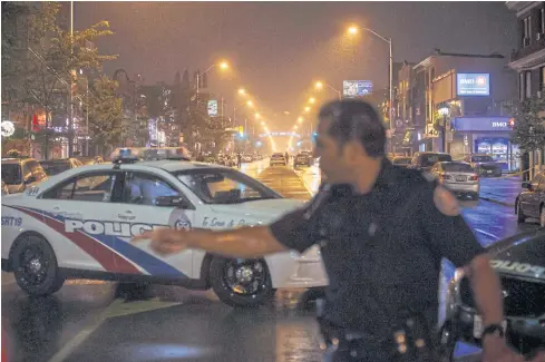  ?? AFP ?? Officers work on Danforth Street at the scene of a shooting in Toronto, Canada yesterday.