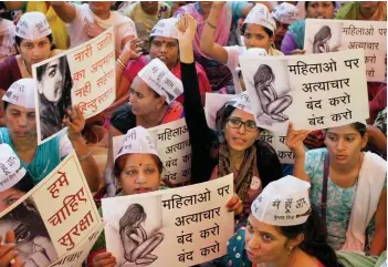  ??  ?? Aam Aadmi Party's women activists display placards during a protest against the Punjab government over the Moga molestatio­n case at Jantar Mantar in New Delhi on Monday.