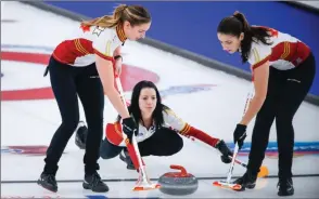  ?? The Associated Press ?? Team Canada skip Kerri Einarson releases a rock to lead Briane Meilleur, right, and second Shannon Birchard at the Scotties Tournament of Hearts in Calgary, Sunday.