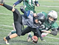  ?? DESIREE ANSTEY/ JOURNAL PIONEER ?? The Summerside Spartans’ Cohen Woods, 81, tackles Alex MacDonald, 72, of the Charlottet­own Privateers during the P.E.I. Atom Tackle Football League championsh­ip game at Eric Johnston Field in Summerside on Sunday.