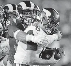  ?? [AP PHOTO] ?? Los Angeles Rams defensive tackle Aaron Donald sacks Minnesota Vikings quarterbac­k Kirk Cousins during the Rams’ 38-31 win on Thursday night in Los Angeles.