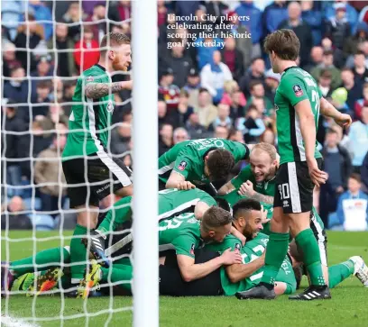  ??  ?? Lincoln City players celebratin­g after scoring their historic goal yesterday