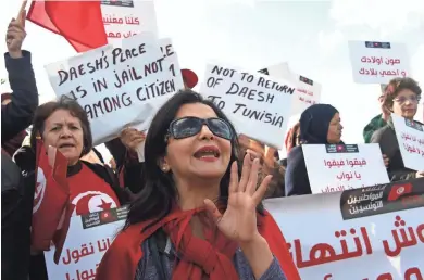  ?? GETTY IMAGES ?? Tunisian women shout slogans during a demonstrat­ion outside parliament Saturday as about 200 people protested in the Tunisian capital against the return of Tunisian jihadis who have fought abroad. The gathering was prompted by the deadly truck attack...