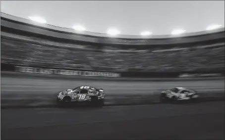  ?? BRIAN LAWDERMILK — GETTY IMAGES ?? Kyle Busch, who earned a rare weekend sweep, races to victory in Saturday’s NASCAR Monster Energy Cup Series race at Bristol Motor Speedway.