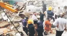  ?? Reuters photo ?? People and rescue personnel are seen after a building collapsed.—