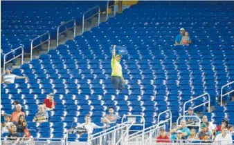  ?? ASSOCIATED PRESS FILE PHOTO ?? A vendor walks through a section of mostly empty seats during the first inning of a game between the Miami Marlins and the New York Mets at Marlins Park stadium in Miami in June. As the All-Star Game comes to Florida for the first time, the Marlins and...