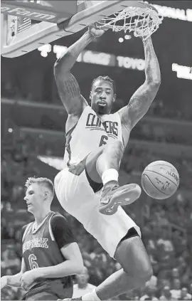  ?? Ryan Kang Associated Press ?? DeANDRE JORDAN THROWS DOWN a dunk for two of his 14 points in the Clippers’ victory over the New York Knicks. Jordan also had 10 rebounds.