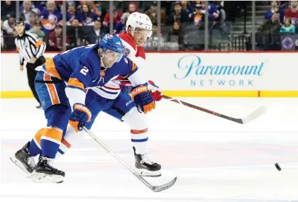  ?? MARY ALTAFFER/THE ASSOCIATED PRESS ?? New York Islanders defenceman Nick Leddy, left, and the Canadiens’ Max Domi chase a loose puck in the first period on Monday in New York. The Habs won 4-3 in a shootout.