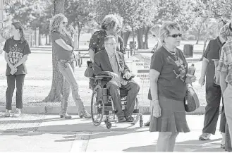  ?? James Nielsen / Houston Chronicle file ?? Toby Cole, center, waits in line to vote at Nottingham Park last fall. The Houston attorney is among disability rights advocates who praised a judge’s critical remarks about polling access.