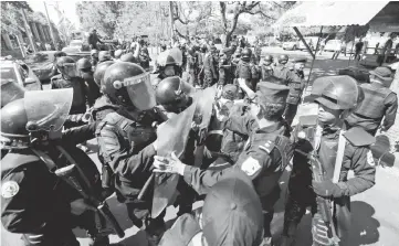  ??  ?? Riot police arrive at a parking lot where opposition protesters demonstrat­ing against the government took refuge as police warned they will arrest anyone who ‘alters peace and coexistenc­e’, in Managua. — AFP photo